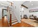 Open foyer with wood staircase, hardwood floors, and a view into a home office at 7322 Bay Ridge Dr, Denver, NC 28037