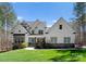 Charming two-story home with a manicured lawn, stone accents, and a welcoming blue front door at 7322 Bay Ridge Dr, Denver, NC 28037