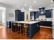 Modern kitchen with navy blue cabinets, a large center island, and stainless steel appliances at 7322 Bay Ridge Dr, Denver, NC 28037