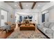 Elegant living room with wood floors, exposed beams and seamless flow to kitchen and dining area at 7322 Bay Ridge Dr, Denver, NC 28037