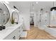 Elegant main bathroom with dual vanities, a soaking tub, and a glass-enclosed shower for a spa-like experience at 7322 Bay Ridge Dr, Denver, NC 28037