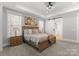 Comfortable main bedroom featuring a tray ceiling, natural light, and easy access to the en-suite bathroom at 7322 Bay Ridge Dr, Denver, NC 28037