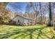 Well-manicured lawn in the backyard with play set, home, and a wood fence at 842 Mary Knoll Ct, Rock Hill, SC 29730