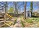 Backyard featuring a play structure, a storage shed, and mature trees, creating a fun and functional outdoor space at 842 Mary Knoll Ct, Rock Hill, SC 29730