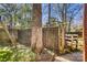 Backyard featuring a rustic wooden fence, a play structure, and lush greenery, creating a private outdoor space at 842 Mary Knoll Ct, Rock Hill, SC 29730