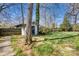 Backyard view with storage shed, mature trees, and lush greenery, creating a private and serene outdoor space at 842 Mary Knoll Ct, Rock Hill, SC 29730