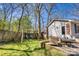 Backyard view featuring a cozy seating area, a swing set, and lush greenery on a sunny day at 842 Mary Knoll Ct, Rock Hill, SC 29730