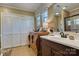 Well-lit bathroom showcasing a dark wood vanity, a marble countertop, and an adjacent closet at 842 Mary Knoll Ct, Rock Hill, SC 29730