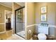 Tiled shower with glass door, toilet, and decorated wall, and a view into another room at 842 Mary Knoll Ct, Rock Hill, SC 29730