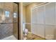 Bathroom featuring a tiled shower, toilet, and access to a large closet at 842 Mary Knoll Ct, Rock Hill, SC 29730