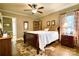 Cozy bedroom with a wooden bed frame, floral rug, and a ceiling fan at 842 Mary Knoll Ct, Rock Hill, SC 29730