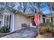 Charming front porch with slate tiles, a bench, and an American flag at 842 Mary Knoll Ct, Rock Hill, SC 29730