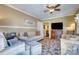 Bright living room featuring elegant sofas, an adjacent television and a patterned area rug at 842 Mary Knoll Ct, Rock Hill, SC 29730