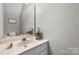 Bathroom featuring single sink vanity with framed mirror and neutral paint at 9068 Cinnabay Dr, Charlotte, NC 28216
