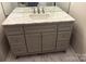 Stylish bathroom vanity with marble countertop, gray cabinetry, and modern fixtures at 9068 Cinnabay Dr, Charlotte, NC 28216