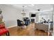 Bright dining area with hardwood floors, chandelier, and access to the living room at 9068 Cinnabay Dr, Charlotte, NC 28216