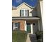 Inviting home exterior featuring a green front door, brick accents, and well-maintained landscaping at 9068 Cinnabay Dr, Charlotte, NC 28216