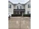 Charming townhome showcasing well-maintained landscaping and inviting front entrance, complete with a welcoming wreath at 9068 Cinnabay Dr, Charlotte, NC 28216