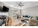 Bright living area with hardwood floors, a ceiling fan, and access to the backyard at 9068 Cinnabay Dr, Charlotte, NC 28216