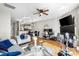 Bright living area with hardwood floors, ceiling fan, and fireplace at 9068 Cinnabay Dr, Charlotte, NC 28216