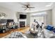Bright living area with hardwood floors, a ceiling fan, and access to the backyard at 9068 Cinnabay Dr, Charlotte, NC 28216