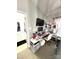 Home office with desk, vanity, TV, and bathroom access showcasing productivity and convenience at 9068 Cinnabay Dr, Charlotte, NC 28216