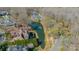 Aerial view of luxurious homes situated on a large pond with a fountain and mature trees at 913 Dacavin Dr, Charlotte, NC 28226