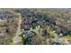 An aerial view showcases a community of single-Gathering homes nestled among mature trees and landscaping at 913 Dacavin Dr, Charlotte, NC 28226