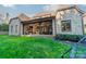 Spacious backyard featuring a covered patio with comfortable seating and an outdoor dining area at 913 Dacavin Dr, Charlotte, NC 28226