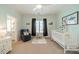 Serene bedroom featuring soft colors, a rocking horse, and a view into the well-appointed bathroom at 913 Dacavin Dr, Charlotte, NC 28226