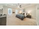 Bright bedroom with tray ceiling, carpet, and large windows providing natural light at 913 Dacavin Dr, Charlotte, NC 28226