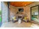 Charming outdoor space with a brick fireplace, cozy seating, and a mounted TV for ultimate relaxation at 913 Dacavin Dr, Charlotte, NC 28226