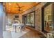 Enjoy the elegant outdoor dining space with a wood-paneled ceiling, fireplace, and serene backyard views at 913 Dacavin Dr, Charlotte, NC 28226