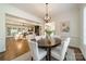 Open-concept dining area with a view into the living room and a stylish chandelier at 913 Dacavin Dr, Charlotte, NC 28226