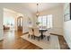 A formal dining room featuring hardwood floors, a modern chandelier, and ample natural light at 913 Dacavin Dr, Charlotte, NC 28226