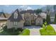 Beautiful two-story home with stone and brick exterior, well-manicured lawn and lush landscaping at 913 Dacavin Dr, Charlotte, NC 28226
