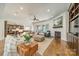 Bright and airy living room featuring hardwood floors, a fireplace, and an open layout to the kitchen at 913 Dacavin Dr, Charlotte, NC 28226