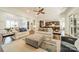 Open-concept living room featuring hardwood floors, ceiling fan, and comfortable seating at 913 Dacavin Dr, Charlotte, NC 28226