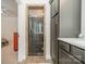 A modern shower with glass doors, stone surround, and tiled floors offers a luxurious bathing experience at 913 Dacavin Dr, Charlotte, NC 28226