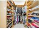 Spacious walk-in closet features custom wooden shelving for ample storage and organization at 913 Dacavin Dr, Charlotte, NC 28226