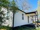 Side exterior of the home with new siding, black trim and a covered porch at 915 2Nd St, Kings Mountain, NC 28086