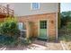The back door is nestled in a brick alcove next to a manicured garden at 1008 High Wedge Rd, Shelby, NC 28152