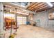 Spacious unfinished basement with block walls and a garage door at 1008 High Wedge Rd, Shelby, NC 28152