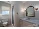 Bathroom with walk-in shower, single sink vanity, linoleum floors and a framed mirror at 1008 High Wedge Rd, Shelby, NC 28152