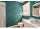 Bathroom featuring a neutral single sink vanity, green wall paper, and a window at 1008 High Wedge Rd, Shelby, NC 28152