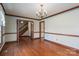 Open dining room with hardwood floors, chandelier, and access to the hallway at 1008 High Wedge Rd, Shelby, NC 28152
