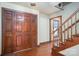 Inviting foyer featuring hardwood floors, grand wooden front door, and staircase at 1008 High Wedge Rd, Shelby, NC 28152