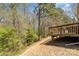 Wooden back deck with wood railing overlooking a green, wooded backyard at 1026 Eagles Nest Ln, Fort Mill, SC 29707