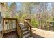 Wooden back deck with wood railing and stairs leading to the backyard at 1026 Eagles Nest Ln, Fort Mill, SC 29707