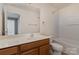 Bathroom with tile flooring, wood vanity, shower and bath combo, and large mirror at 1026 Eagles Nest Ln, Fort Mill, SC 29707